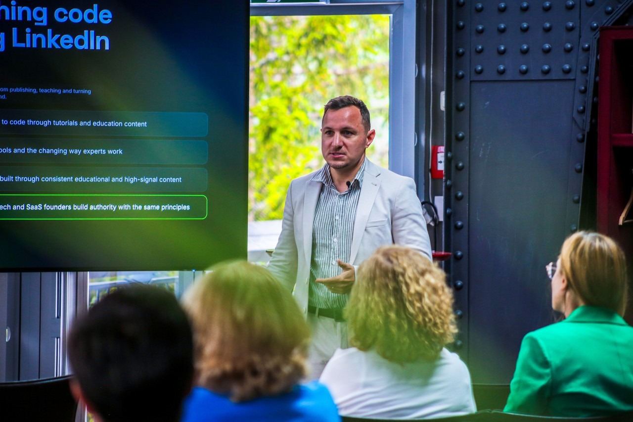 Denis Panjuta speaking on stage in Austria